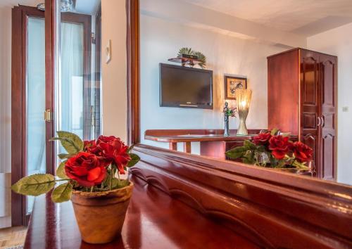 a living room with a couch with flowers on it at Villa Roses Apartments & Wellness in Ičići