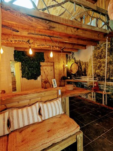 a room with a bench and a table and swings at Les Spas de la mer, Appart&Spa Canopée, 100m de la plage, Love Room in Le Grau-du-Roi