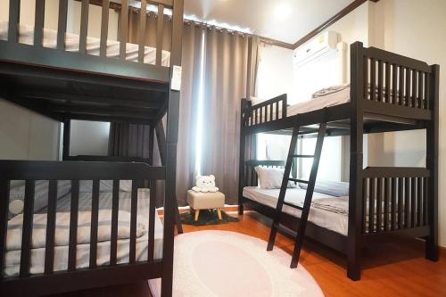 two bunk beds in a room with a bedroom at Pipim villa in Ban Chak Makham