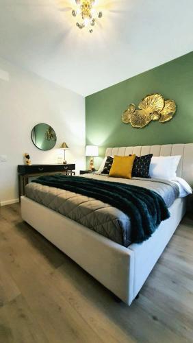 a large bedroom with a large bed with yellow pillows at Aze - Green Business in Bucharest