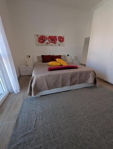 a bedroom with a large bed with a rug at Apartment Eleven - 4 guests in Novara