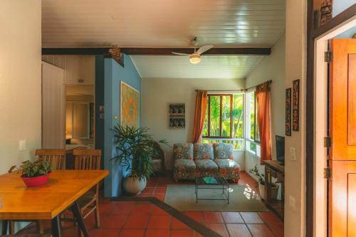 a living room with a couch and a table at Pousada Vila Tamarindo Eco Lodge in Florianópolis