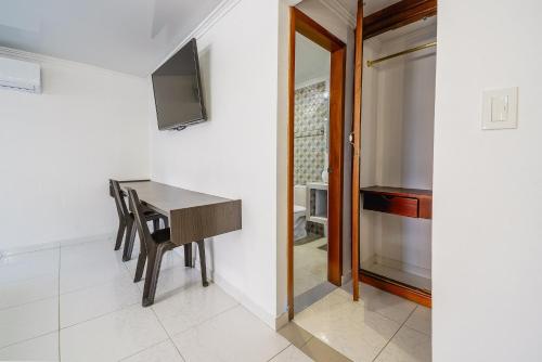 Télévision ou salle de divertissement dans l'établissement Villa Santos Apartaestudios