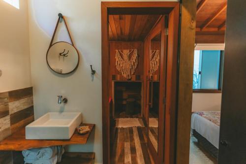 a bathroom with a sink and a mirror at Pousada Vila Tamarindo Eco Lodge in Florianópolis