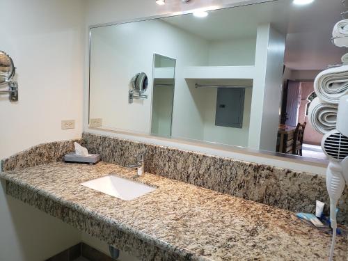 a bathroom with a sink and a large mirror at La Villa de Zaragoza in Tijuana