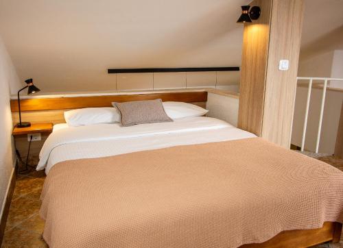 a bedroom with a large bed in a room at Guest House Jedro in Petrovac na Moru