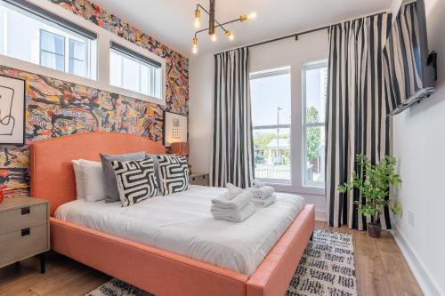 a bedroom with a bed and a wall of windows at Henley at The Lucy by Stay Local Nashville in Nashville