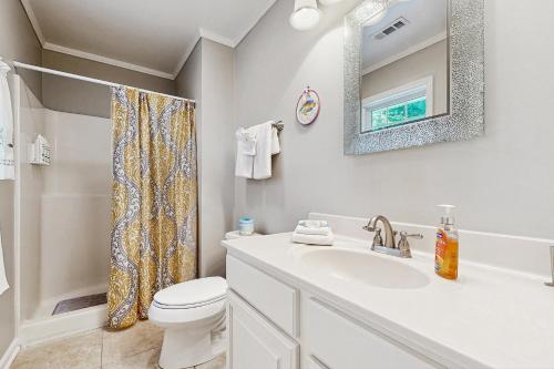 a bathroom with a sink and a toilet and a mirror at Candlelight Acres - 530 Candlelight in Bethany Beach