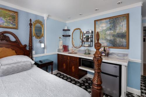 a bedroom with a bed and a vanity with a mirror at The Irish Inn in Hood River