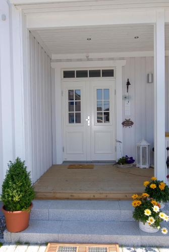 a white front door of a white house at Villa Scandic Apartments in Rust