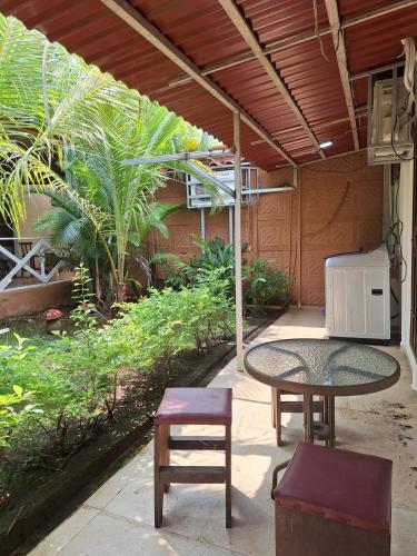 a patio with a table and a chair and a table and bench at Villa en Orotina con Piscina in Coyolar