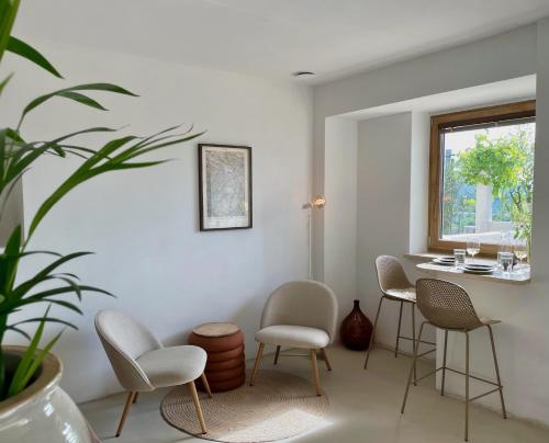 a room with chairs and a table and a window at Vipava View Studio Apartments in Šempas