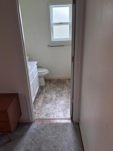 a bathroom with a toilet and a window at North Marysville Home in Marysville