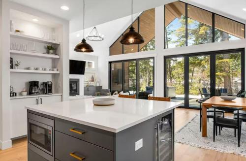 a kitchen with a large island with a white counter top at Panorama Pines in Suncadia- Hot Tub, BBQ, Firepit, Outdoor Seating, Fully Equipped Kitchen, Smart TVs, Hi-speed Wi-Fi in Cle Elum