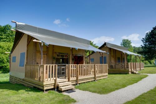 a couple of cottages sitting in a field at Sunny Lodge 6 persoons in Zeewolde
