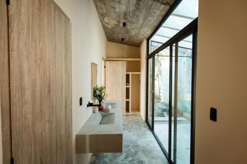 a hallway of a house with a large window at Casa Xul in Tulum