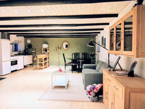 a living room with a couch and a table at Ferielejlighed i landlige omgivelser in Ørsted