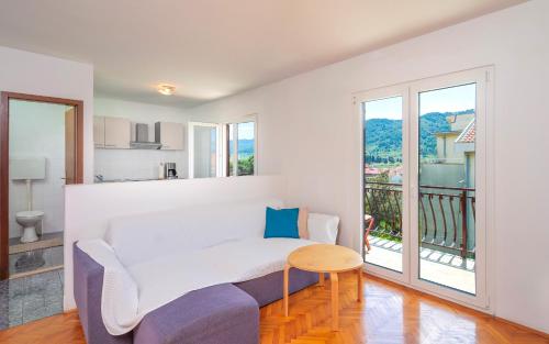 a living room with a couch and a table at Apartments Dulcic in Stari Grad