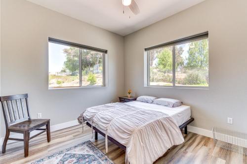 a bedroom with a bed and two windows at Family Hideaway with Hillside Views in Temecula! in Temecula