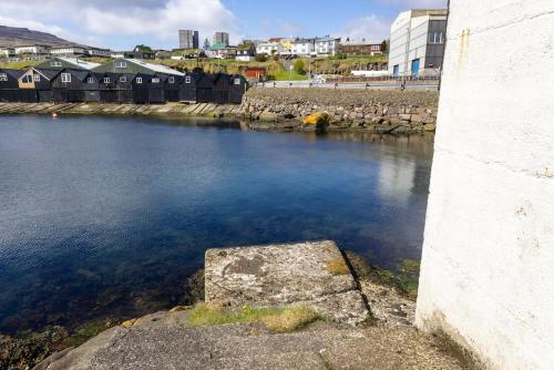 a view of a river with buildings in the background at Luxury Boat House in City Center in Tórshavn