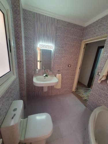 a bathroom with a sink and a toilet at Madinaty modern cozy apartment in Madinaty