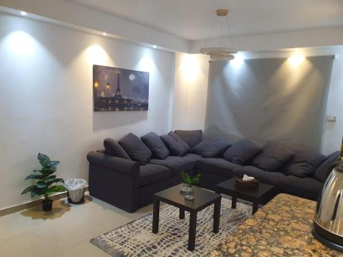 a living room with a couch and a table at Madinaty modern cozy apartment in Madinaty