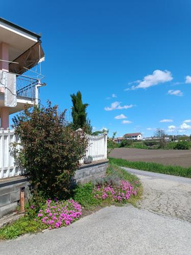 a house with pink flowers next to a white fence at Villa Pia in Casalgrasso