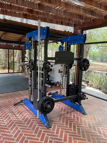 a gym with blue equipment on a brick floor at CC Beach Front Papagayo All Inclusive in Papagayo, Guanacaste