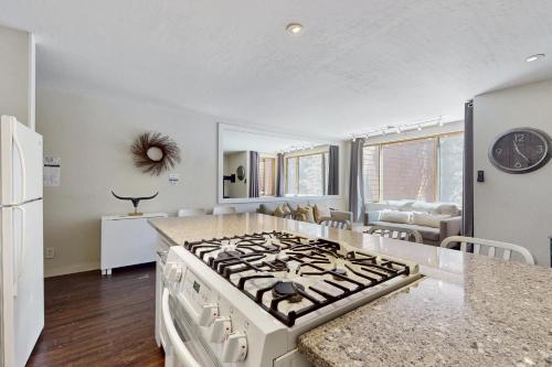 a kitchen with a stove top oven in a room at Cozy Coyote Fork Condo in Truckee