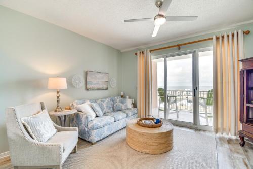 a living room with a couch and a table at Walk to Beach Condo with Balcony in Gulf Shores! in Gulf Shores