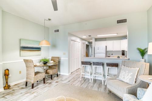 a living room and kitchen with a table and chairs at Walk to Beach Condo with Balcony in Gulf Shores! in Gulf Shores