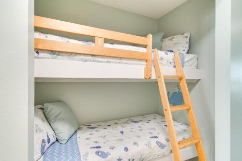 a bedroom with bunk beds with a ladder at Walk to Beach Condo with Balcony in Gulf Shores! in Gulf Shores