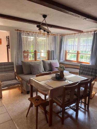 a living room with a couch and a table at Chata pod Luhačovickou přehradou in Pozlovice