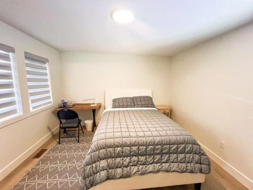 a bedroom with a bed and a desk in it at Morning Dew105 in Hammonds Plains