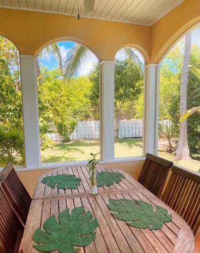 a dining room with a table with leaves on it at Shangri-La Boutique Bed & Breakfast in West Bay
