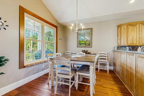 a kitchen with a dining room table and chairs at Restful Adventure On The Coast in Harrington
