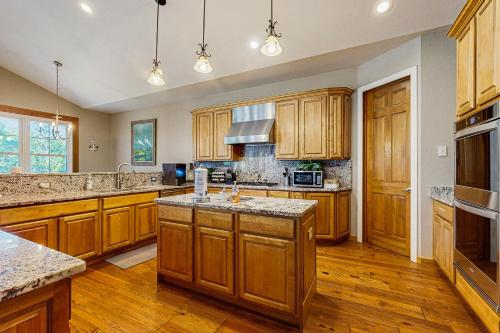 a large kitchen with wooden cabinets and wooden floors at Restful Adventure On The Coast in Harrington