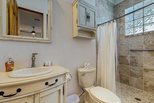a bathroom with a toilet and a sink and a shower at Restful Adventure On The Coast in Harrington