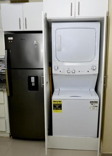 a refrigerator and a microwave in a kitchen at Peaceful 2 Bed Apartment - Pool & Private Beach Access in Punta Cana