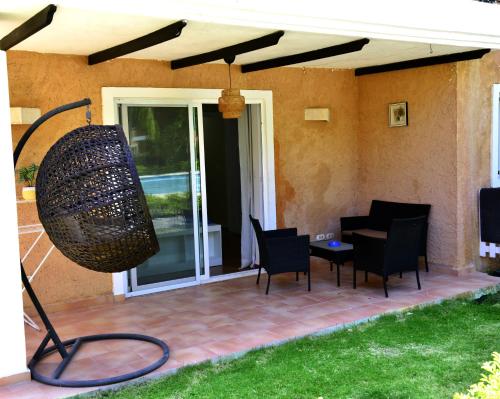 a patio with a table and chairs and a basket at Peaceful 2 Bed Apartment - Pool & Private Beach Access in Punta Cana
