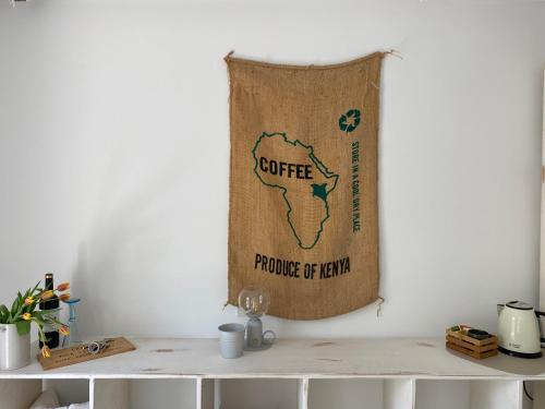a flag hanging on a wall next to a table at Helles 1-Raum Studio mit eigenem Bad & Terasse in Hannover