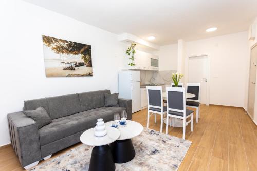 a living room with a couch and a table at Apartments Ivo Herceg Novi in Herceg-Novi