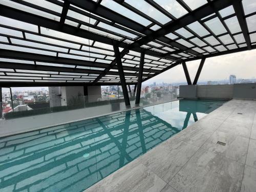 a swimming pool on the roof of a building at Apartment in La Roma, Pool&GYM in Mexico City