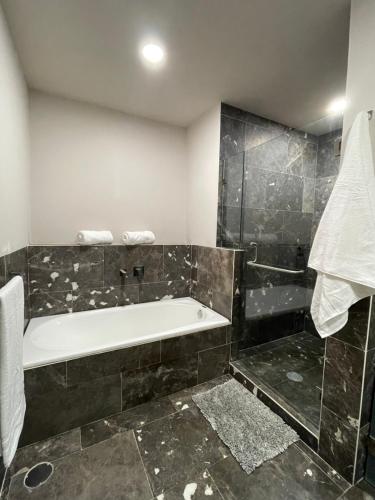 a bathroom with a bath tub and a shower at Apartment in La Roma, Pool&GYM in Mexico City