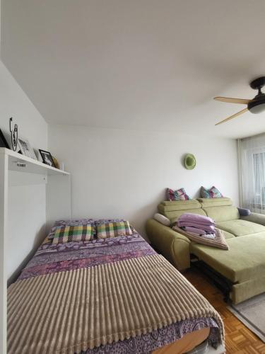 a living room with a bed and a couch at Dolly Apartment Airport in Velika Gorica