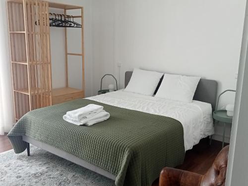 a bedroom with a bed with two towels on it at Beach Avenue Suite in Apúlia