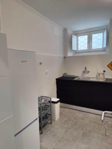 a kitchen with a sink and a counter at Blue House Amadora City in Amadora
