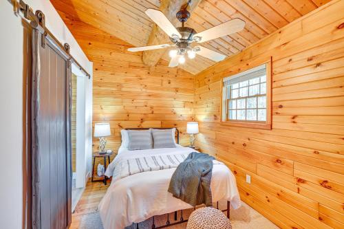 a bedroom with a bed and a ceiling fan at 4 Mi to Dtwn Spacious Family Cabin in Jonesville! in Jonesville
