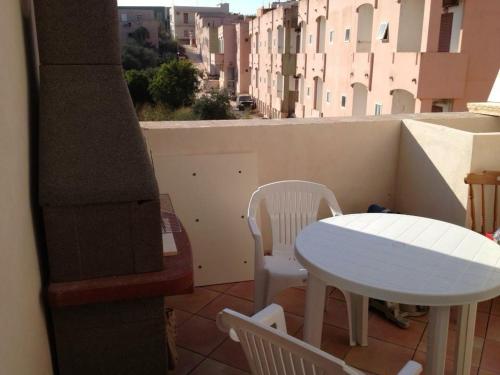 a white table and chairs on a balcony with a table at Stella Marina in Lampedusa