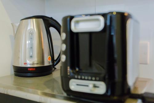 a coffee maker and a toaster on a counter at Accra Luxury Apartments at The Gallery in Accra